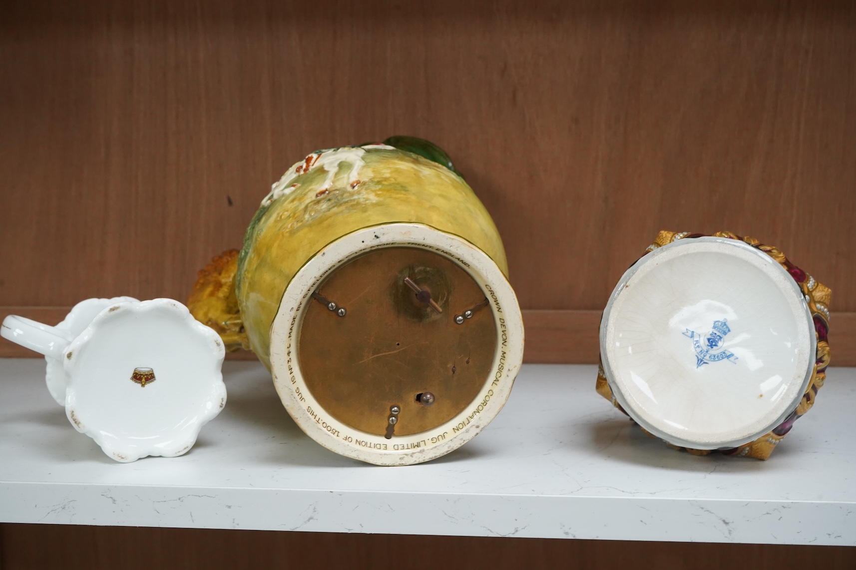 A Crown Devon George VI musical coronation jug, a crown shaped jar with plated cover and a coronation cup, largest 32cm high